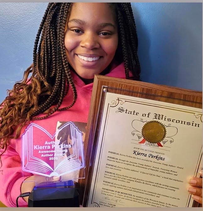 Award-winning young author with her books and award